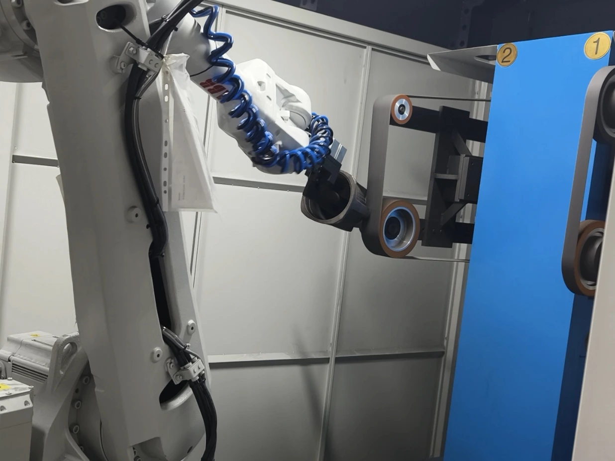 Robotic belt grinding removes excess material from metal parts