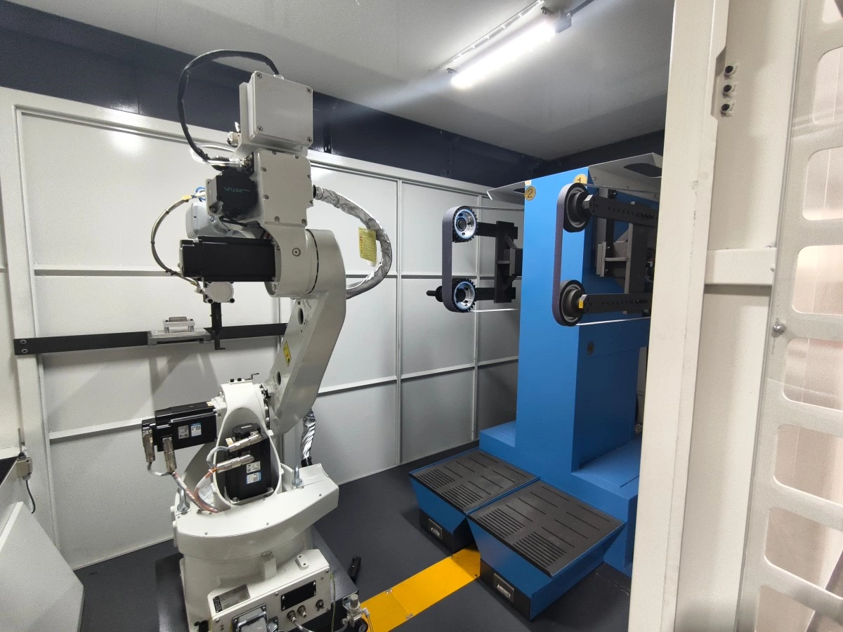 robotic weld grinding cell with custom fixture